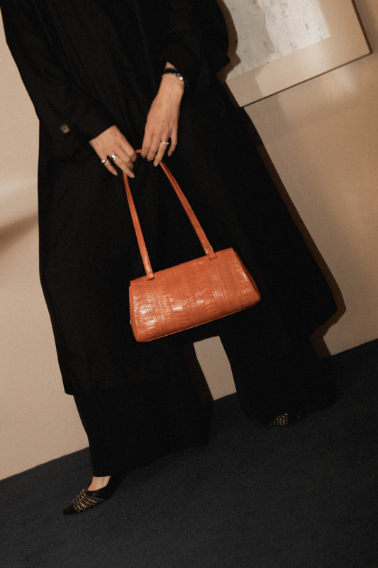 Cape Cobra luxury ostrich leather handbag displayed with gold hardware and rich texture.