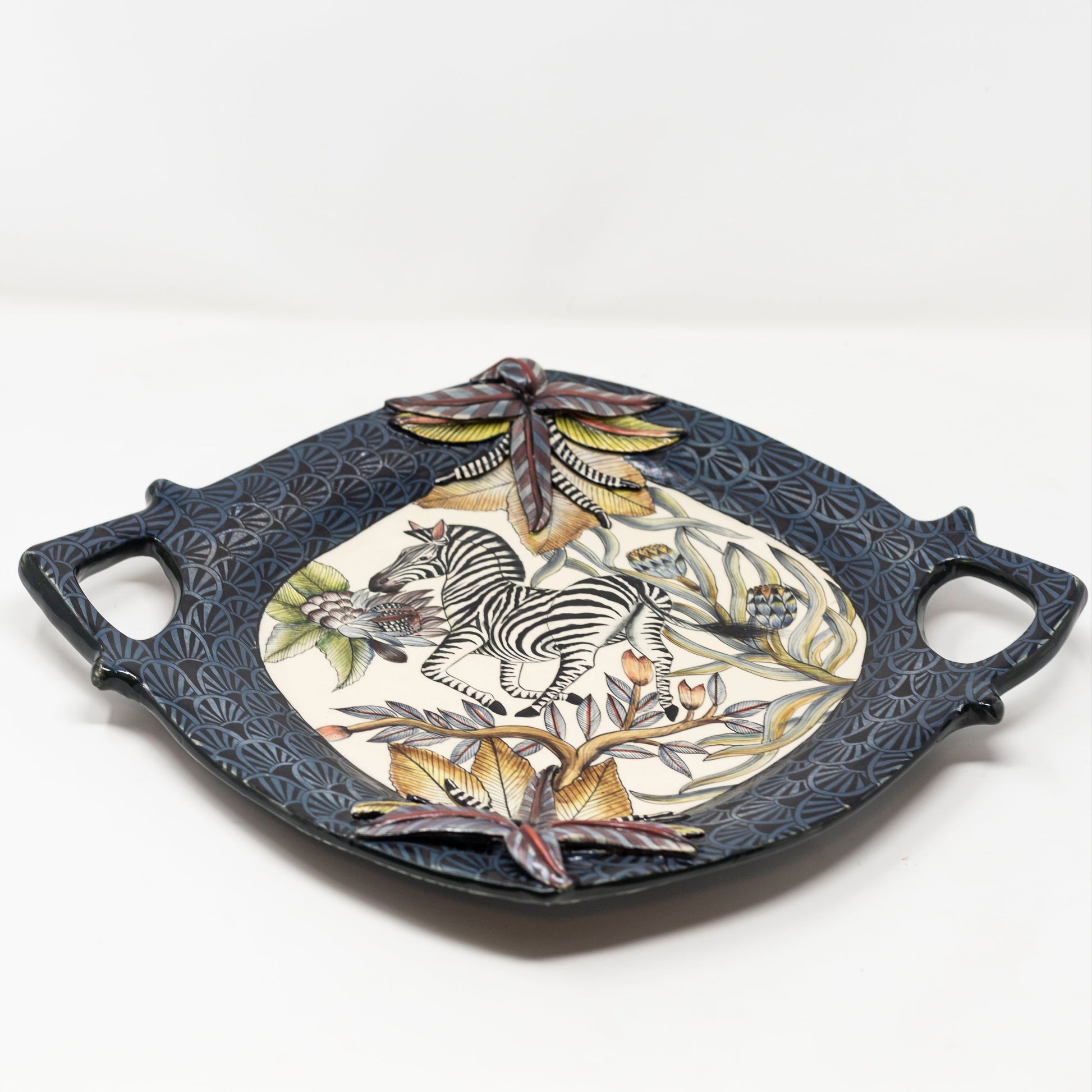 Decorative ceramic tray with zebra design on a white background