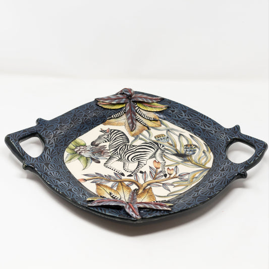 Decorative ceramic tray with zebra design on a white background